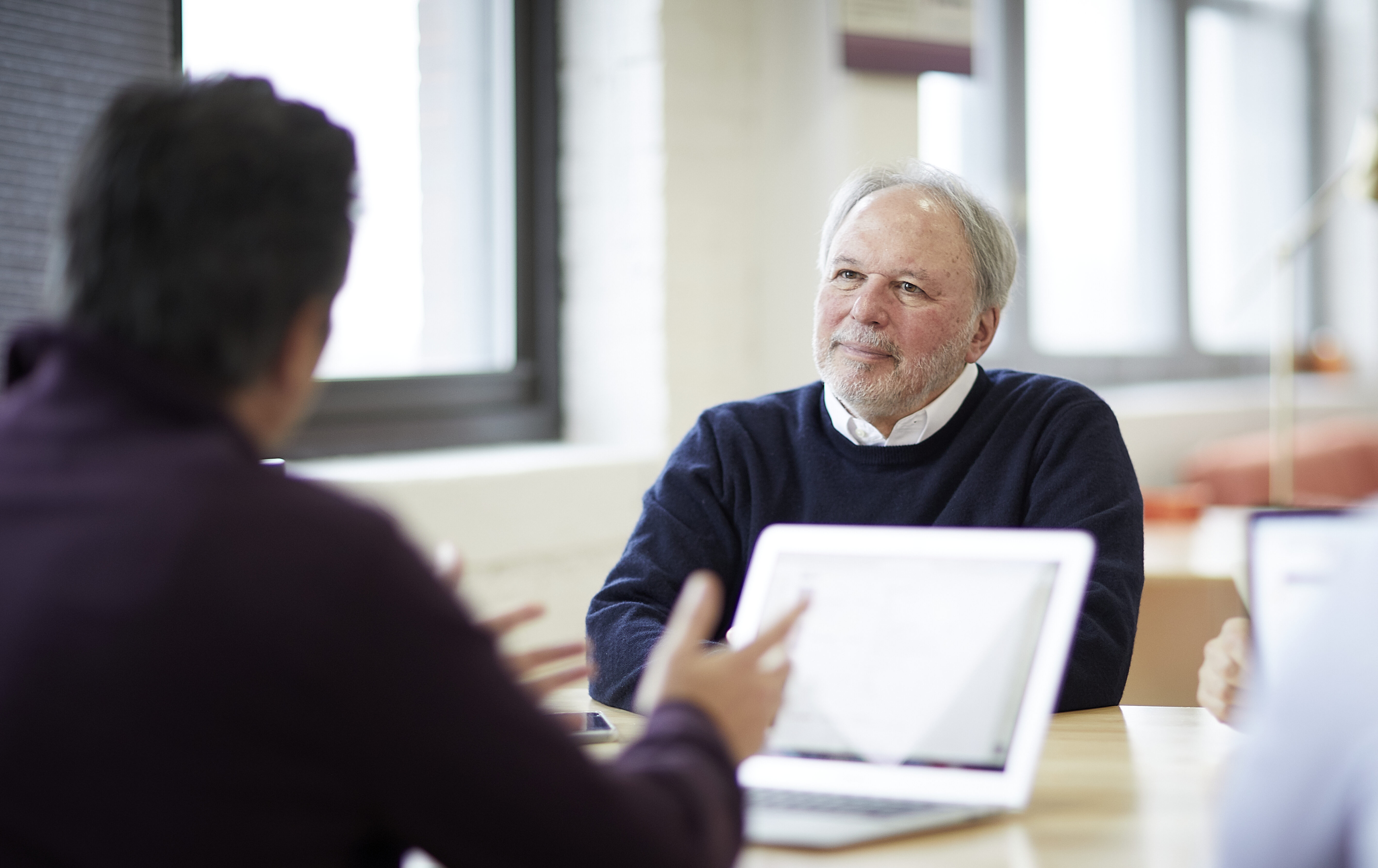 Photo of Senior Director, Dan Bauer listening intently in a meeting with a client.