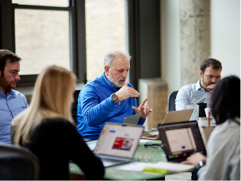 Scott Markman, Founder/President explaining an idea to the MonogramGroup internal team during a meeting at the office.