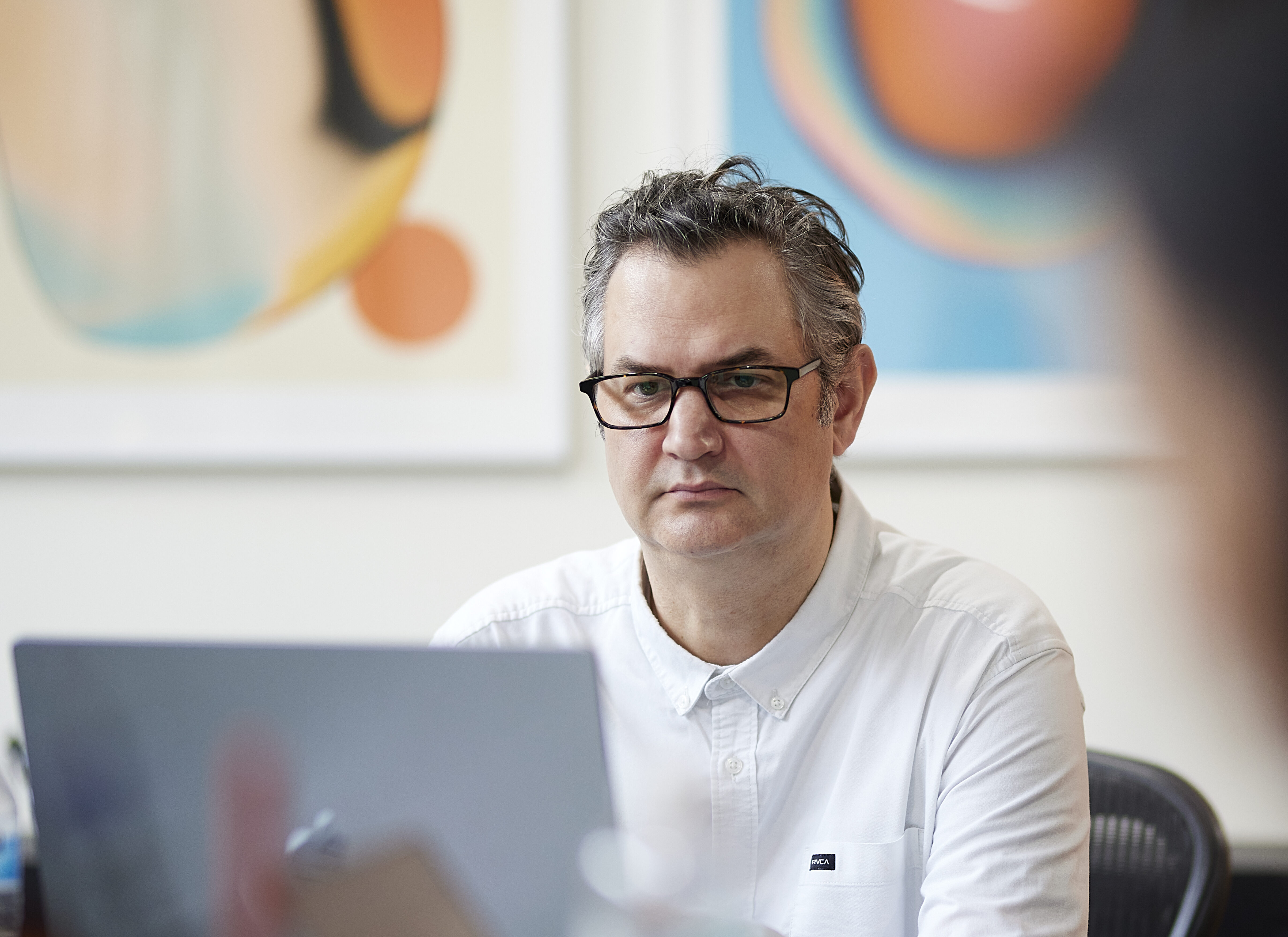 Photo of Senior Art Director, Sean Fermoyle deep in concentration on his computer.