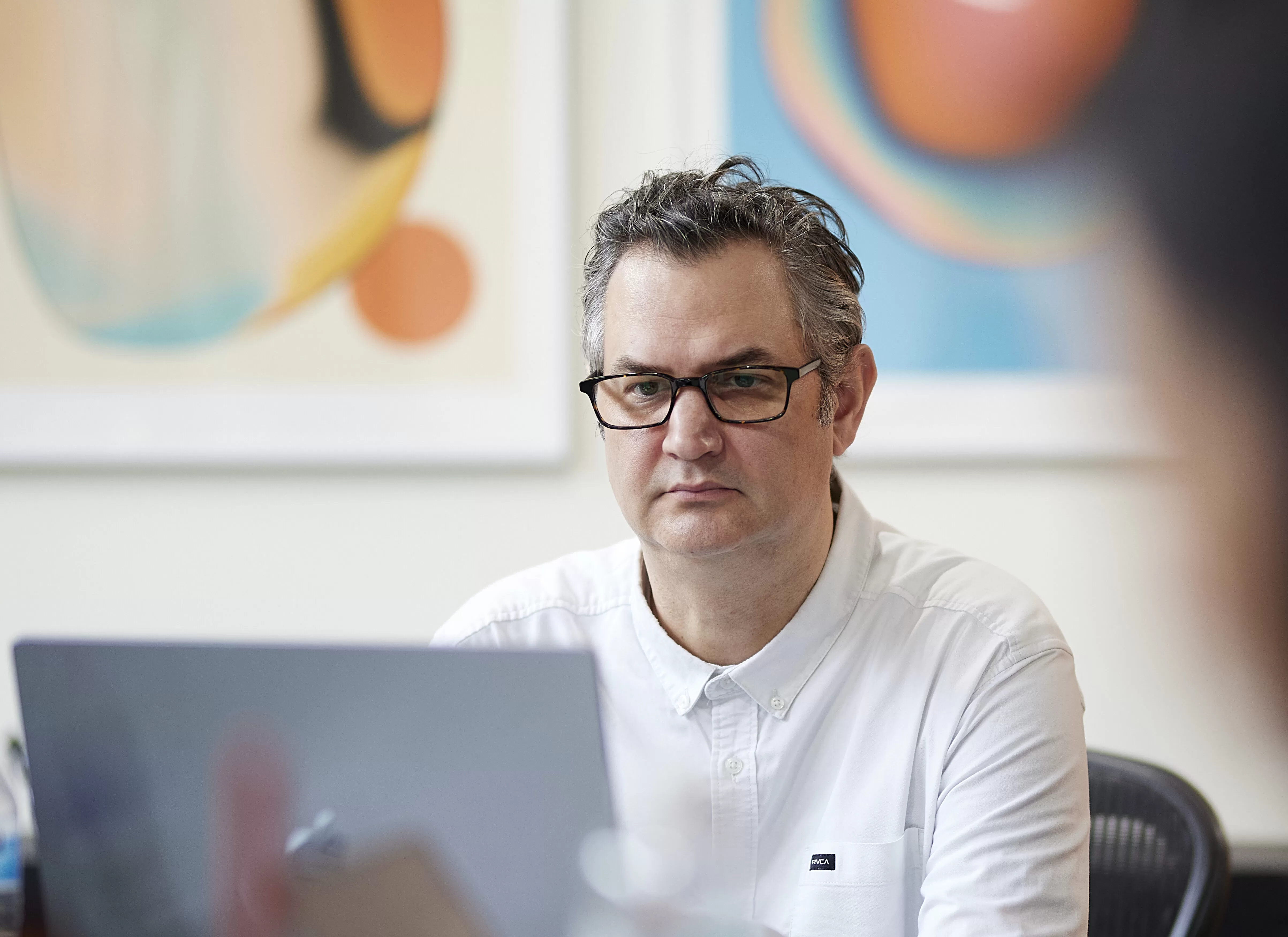 Photo of Senior Art Director, Sean Fermoyle deep in concentration on his computer.