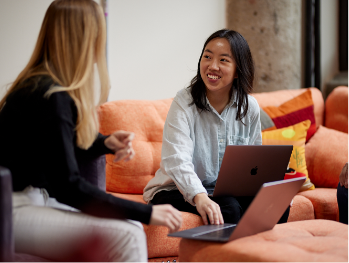 MonogramGroup Hero Photo of (Left) Account Executive Intern, Madison August and (Right) Design Intern, Ali Walsh collaborating on a work project.