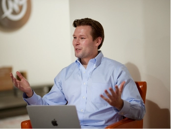 MonogramGroup Hero Photo of Kevin Grube laughing at the absurdity of a hilarious joke.