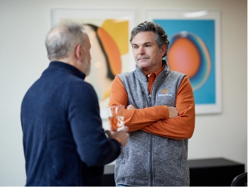 MonogramGroup Hero Photo of (Left) President, Scott Markman and (Right) Partner/Creative Director, Chip Balch conversing at the office.