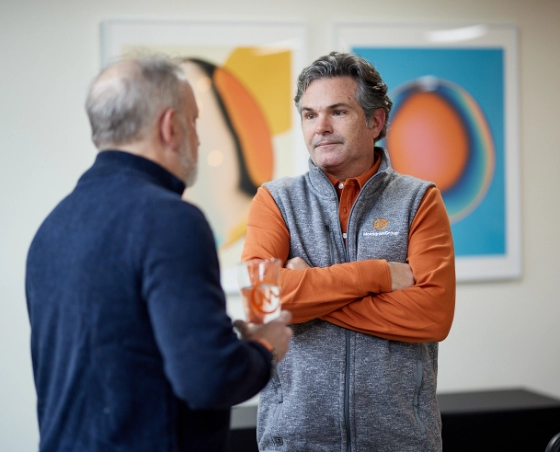 MonogramGroup Hero Photo of (Left) President, Scott Markman and (Right) Partner/Creative Director, Chip Balch conversing at the office.