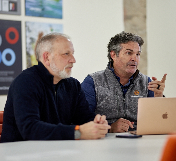 (Left) President Scott Markman and (Right) Partner/Creative Director Chip Balch participate in a team meeting.