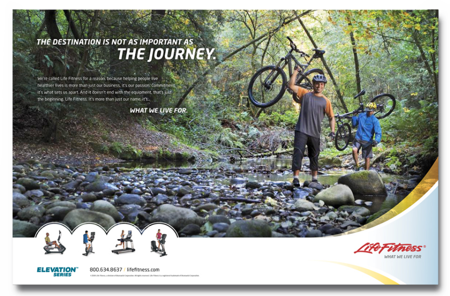 Two people wearing helmets and holding bicycles stand in a shallow stream amidst a forest. Text reads, The destination is not as important as the journey. Life Fitness branding and images of exercise equipment are at the bottom.