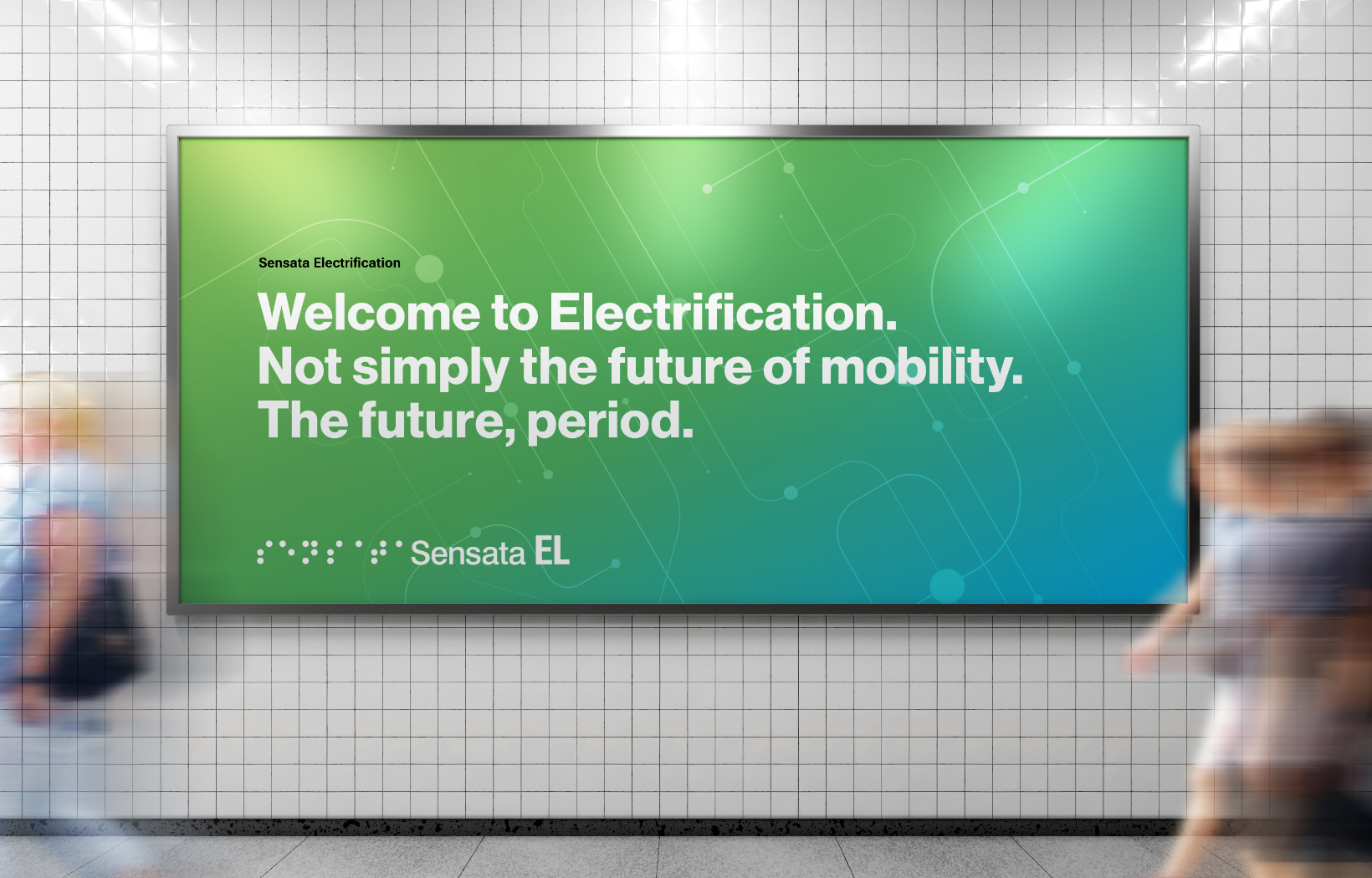 A large green billboard in a subway station reads, Welcome to Electrification. Not simply the future of mobility. The future, period. Its attributed to Sensata Electrification. Blurry figures of people are walking past.