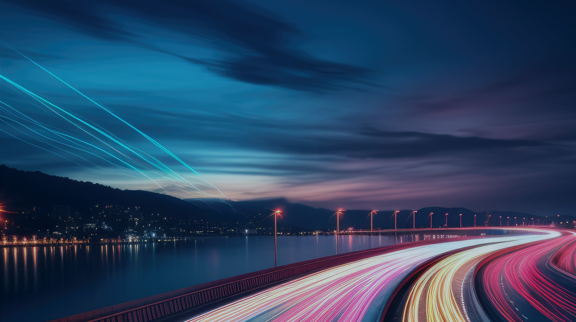 A long exposure shot of a bridge at night with light trails from vehicles. The sky has a gradient of blue to purple with streaks of clouds. The bridge curves elegantly, illuminated by streetlights, and a body of water is visible below.
