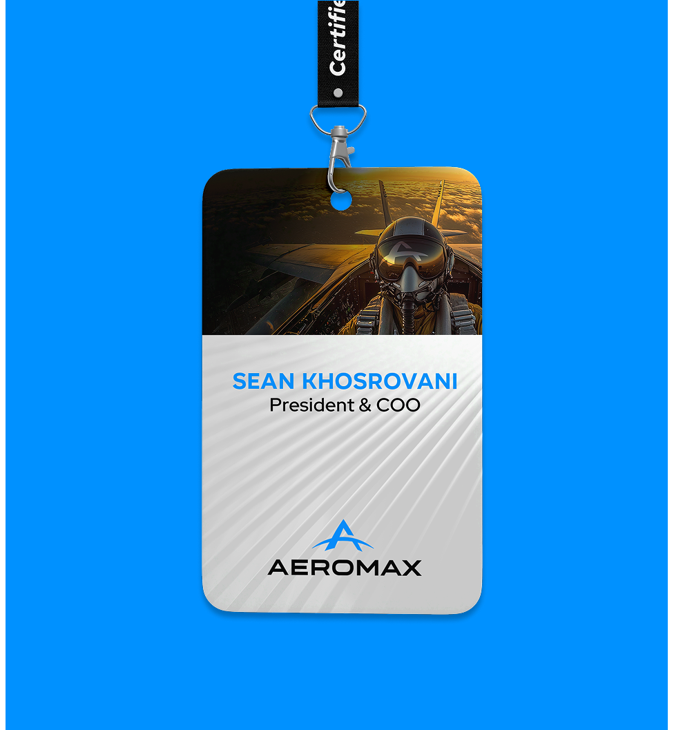 A staff badge with a lanyard, featuring an image of a pilot in a cockpit. The text reads Sean Khosrovani, President & COO. Below is the Aeromax logo on a white and gray background.